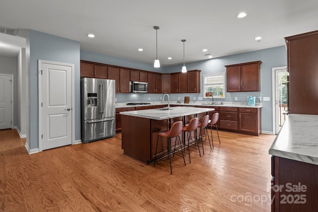 1230 Long Creek Ln, Salisbury, NC 28146 - kitchen featuring appliances with stainless steel finishes, a sink, light countertops, light wood-style floors, and recessed lighting