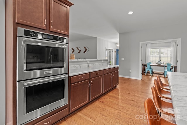 1230 Long Creek Ln, Salisbury, NC 28146 - kitchen with double oven, light wood-style flooring, baseboards, and recessed lighting
