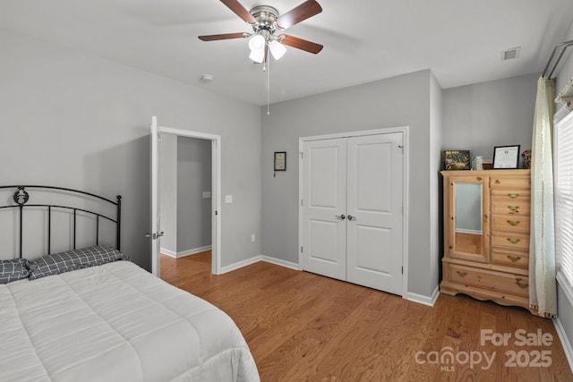 1230 Long Creek Ln, Salisbury, NC 28146 - bedroom featuring wood finished floors, baseboards, a closet, and a ceiling fan