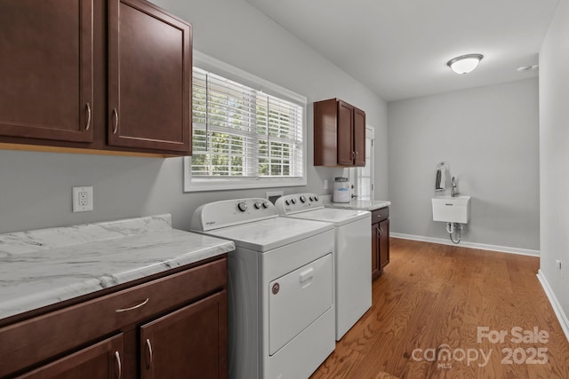 1230 Long Creek Ln, Salisbury, NC 28146 - laundry room with cabinet space, washer and clothes dryer, light wood-type flooring, and baseboards