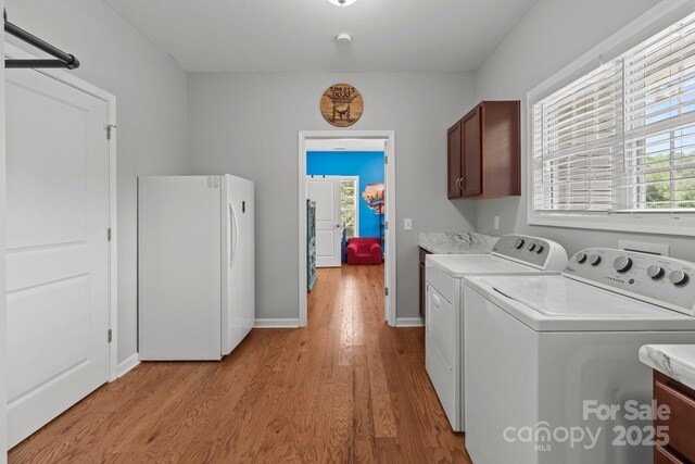 1230 Long Creek Ln, Salisbury, NC 28146 - laundry room featuring cabinet space, washing machine and clothes dryer, light wood-style floors, and baseboards