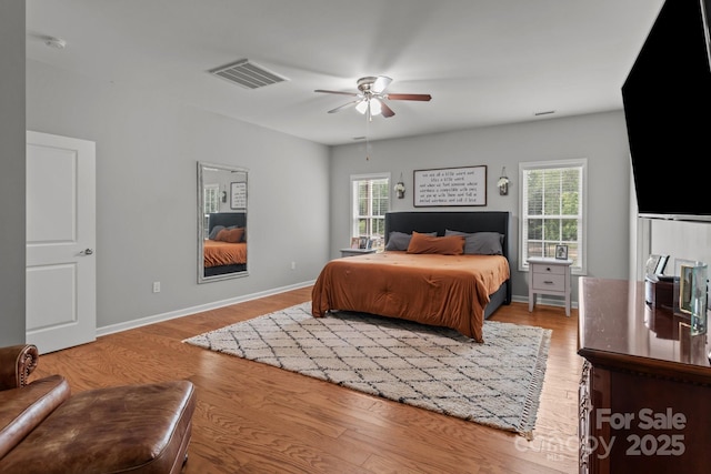 1230 Long Creek Ln, Salisbury, NC 28146 - bedroom with multiple windows, wood finished floors, ceiling fan, and baseboards