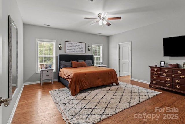 1230 Long Creek Ln, Salisbury, NC 28146 - bedroom featuring multiple windows, wood finished floors, baseboards, and a ceiling fan