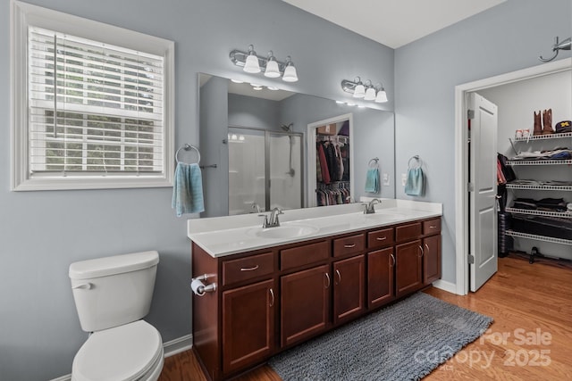 1230 Long Creek Ln, Salisbury, NC 28146 - full bathroom featuring a stall shower, wood finished floors, double vanity, a spacious closet, and toilet