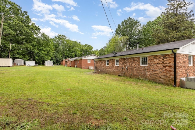16 Green St, York, SC 29745 - view of green lawn with a storage unit, an outdoor structure, and central AC