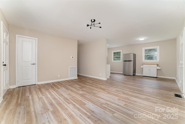 16 Green St, York, SC 29745 - unfurnished living room with light wood-style floors and baseboards