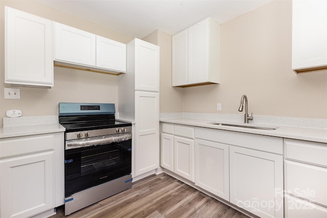 16 Green St, York, SC 29745 - kitchen featuring electric range, a sink, white cabinetry, and light countertops