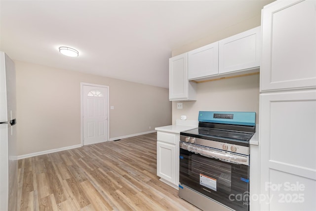 16 Green St, York, SC 29745 - kitchen featuring stainless steel range with electric cooktop, light wood-style flooring, white cabinetry, and light countertops