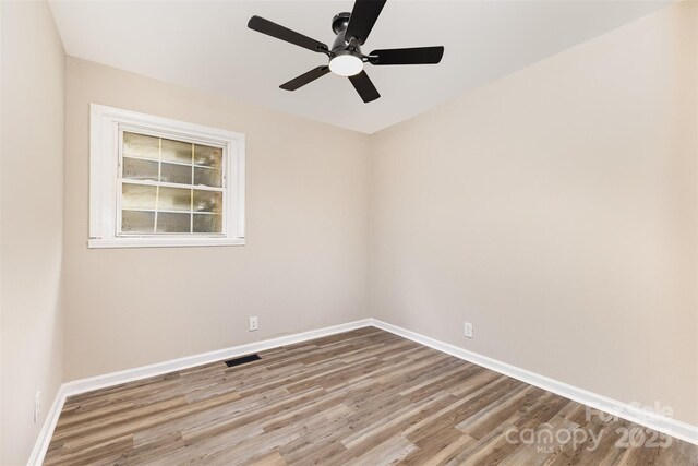 16 Green St, York, SC 29745 - empty room with wood finished floors, baseboards, and ceiling fan