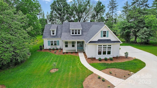 9311 Simpson Rd, Waxhaw, NC 28173 - view of front facade with a front yard, roof with shingles, concrete driveway, and view of scattered trees
