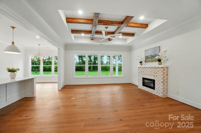 9311 Simpson Rd, Waxhaw, NC 28173 - unfurnished living room with plenty of natural light, beamed ceiling, coffered ceiling, a brick fireplace, and light wood-style flooring