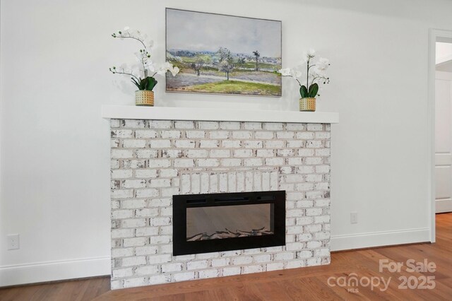9311 Simpson Rd, Waxhaw, NC 28173 - detailed view of baseboards, a fireplace, and wood finished floors