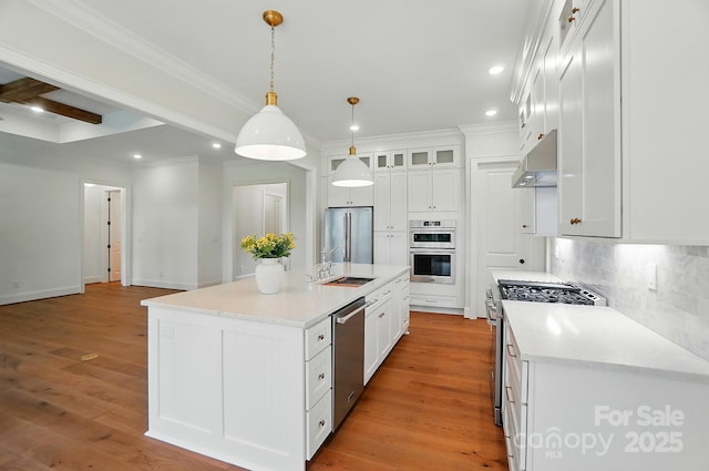 9311 Simpson Rd, Waxhaw, NC 28173 - kitchen with stainless steel appliances, a sink, under cabinet range hood, backsplash, and white cabinets