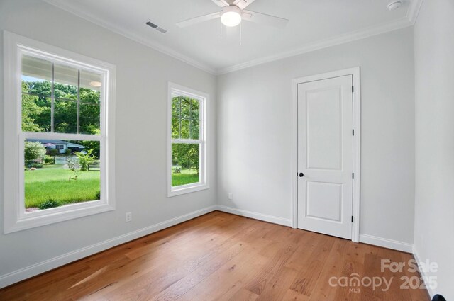 9311 Simpson Rd, Waxhaw, NC 28173 - empty room featuring light wood-style floors, crown molding, baseboards, and a ceiling fan