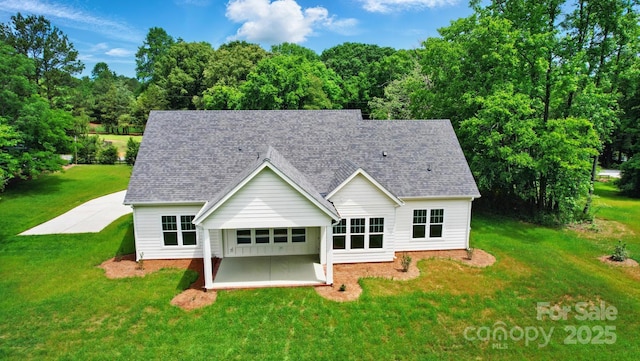 9311 Simpson Rd, Waxhaw, NC 28173 - rear view of property featuring a patio, a yard, and a shingled roof