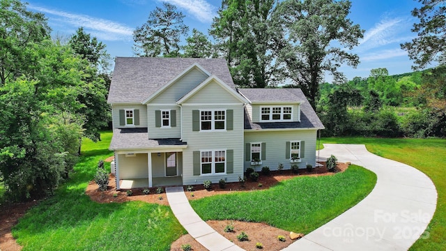 9315 Simpson Rd, Waxhaw, NC 28173 - view of front of house featuring a shingled roof, a front yard, and covered porch