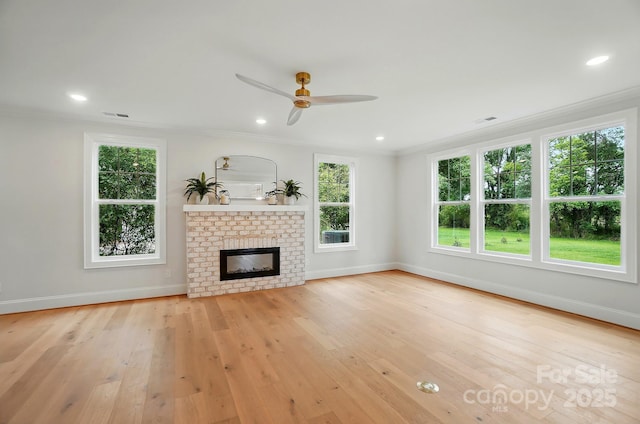 9315 Simpson Rd, Waxhaw, NC 28173 - unfurnished living room featuring crown molding, baseboards, healthy amount of natural light, ceiling fan, and a fireplace