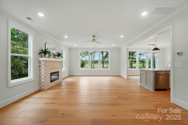 9315 Simpson Rd, Waxhaw, NC 28173 - unfurnished living room with ornamental molding, baseboards, ceiling fan, a fireplace, and light wood finished floors