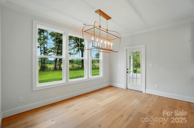 9315 Simpson Rd, Waxhaw, NC 28173 - unfurnished dining area with crown molding, baseboards, a chandelier, and hardwood / wood-style flooring
