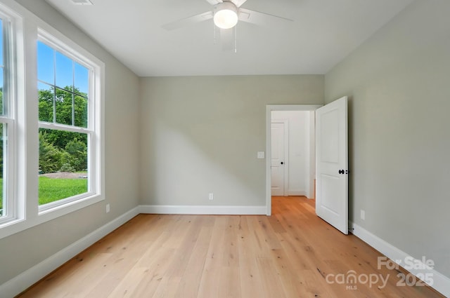 9315 Simpson Rd, Waxhaw, NC 28173 - empty room featuring plenty of natural light, light wood-style floors, baseboards, and a ceiling fan