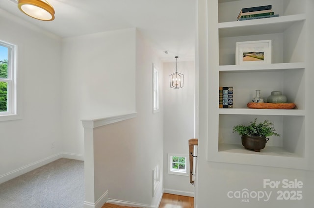 9315 Simpson Rd, Waxhaw, NC 28173 - hall with baseboards, built in shelves, and a chandelier