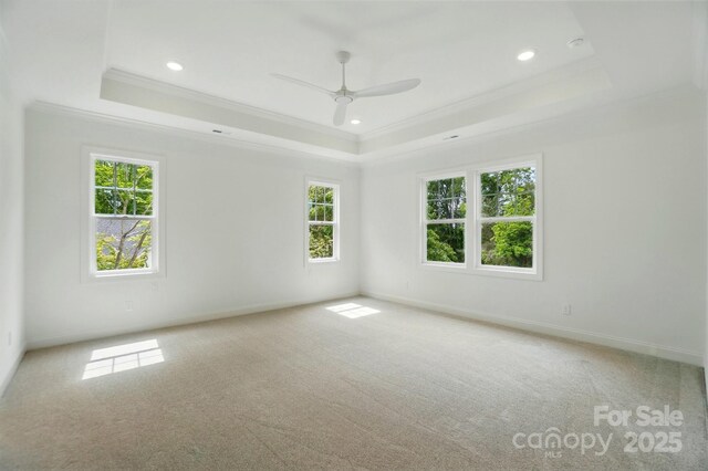 9315 Simpson Rd, Waxhaw, NC 28173 - unfurnished room with a tray ceiling, ornamental molding, light colored carpet, ceiling fan, and recessed lighting