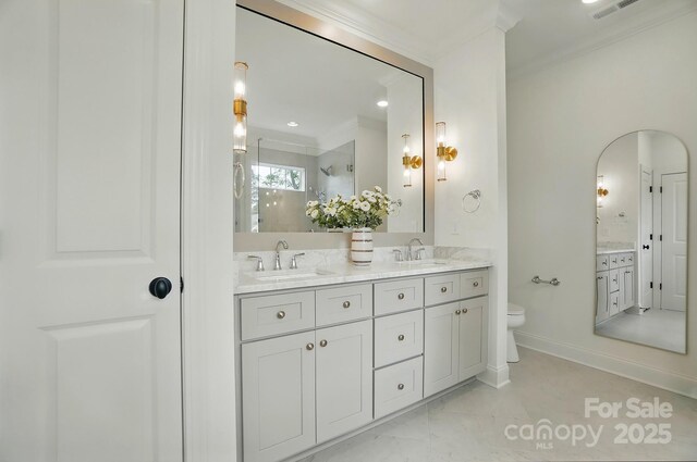 9315 Simpson Rd, Waxhaw, NC 28173 - bathroom featuring a shower stall, double vanity, crown molding, toilet, and baseboards