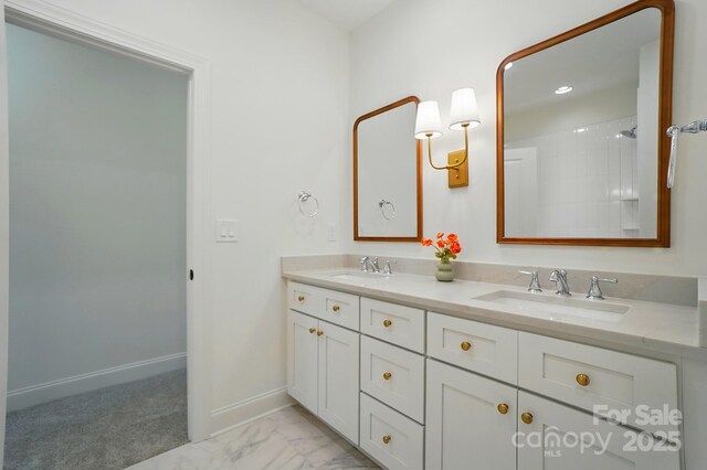 9315 Simpson Rd, Waxhaw, NC 28173 - bathroom with double vanity, baseboards, and marble finish flooring