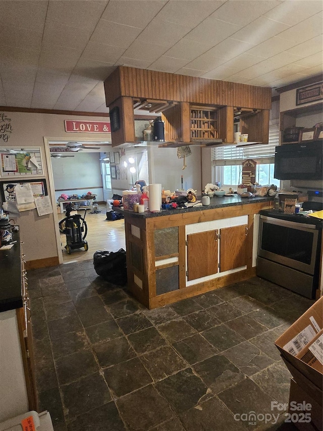 29386 Nelson Mountain Rd, Albemarle, NC 28001 - kitchen with plenty of natural light, stone tile flooring, stainless steel electric range oven, and dark countertops