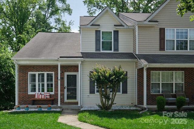 327 Wilkes Place Dr, Fort Mill, SC 29715 - view of front of home featuring brick siding, a front lawn, and roof with shingles