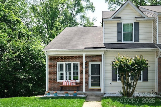 327 Wilkes Place Dr, Fort Mill, SC 29715 - view of front of home featuring brick siding, roof with shingles, and covered porch