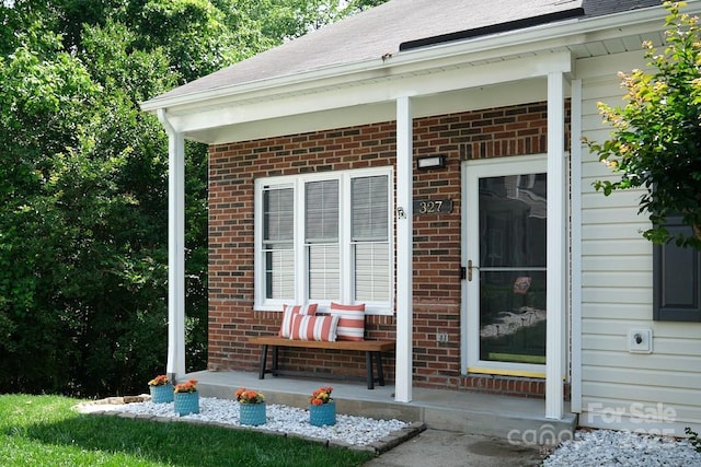 327 Wilkes Place Dr, Fort Mill, SC 29715 - entrance to property with a porch, brick siding, and a shingled roof
