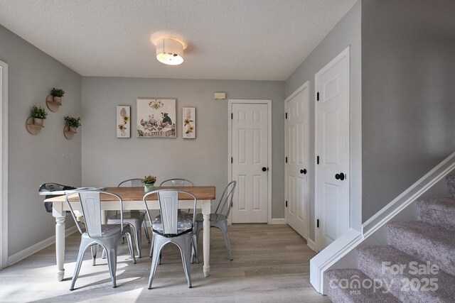 327 Wilkes Place Dr, Fort Mill, SC 29715 - dining room with wood finished floors, stairway, baseboards, and a textured ceiling