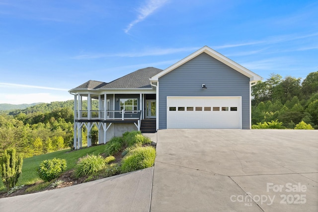 505 Sky Ridge Dr Unit 57, Leicester, NC 28748 - ranch-style house with covered porch, concrete driveway, a garage, and roof with shingles