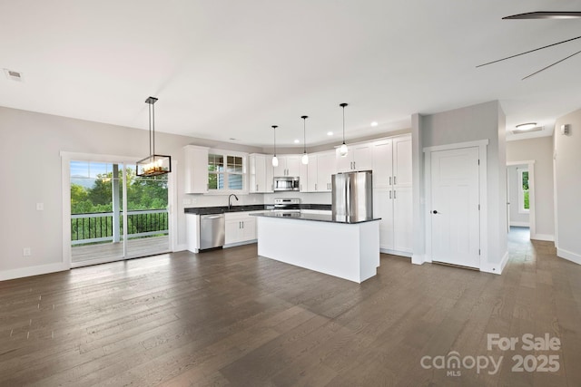 505 Sky Ridge Dr Unit 57, Leicester, NC 28748 - kitchen featuring appliances with stainless steel finishes, healthy amount of natural light, white cabinets, baseboards, and recessed lighting