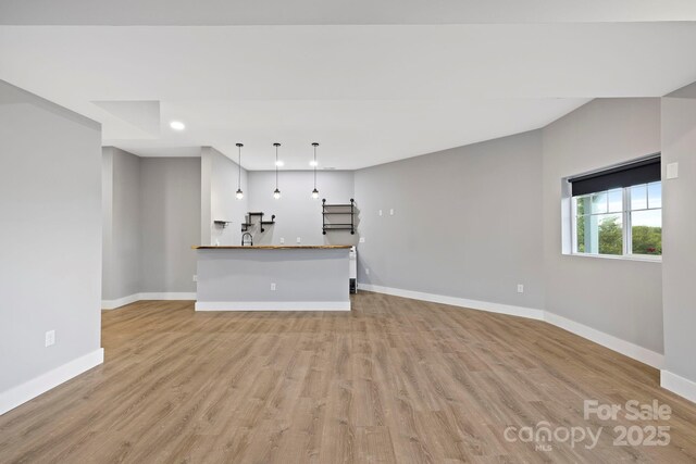 505 Sky Ridge Dr Unit 57, Leicester, NC 28748 - unfurnished living room featuring baseboards, light wood-style floors, and recessed lighting