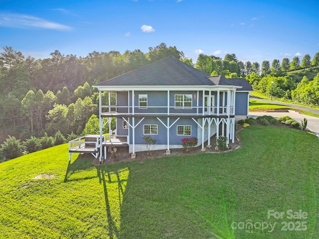 505 Sky Ridge Dr Unit 57, Leicester, NC 28748 - back of house featuring a balcony, a yard, and a wooded view