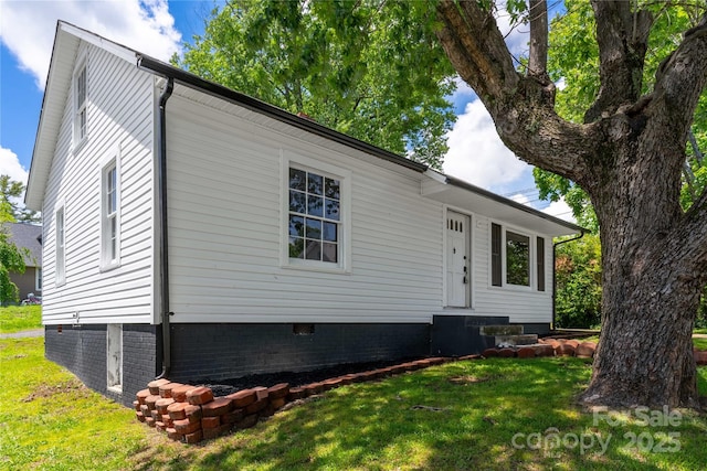 rear view of property featuring crawl space, a yard, and central AC