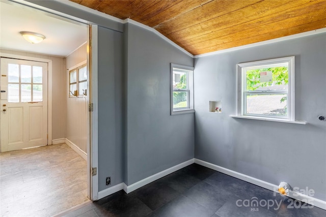 unfurnished room with wood ceiling, lofted ceiling, and baseboards