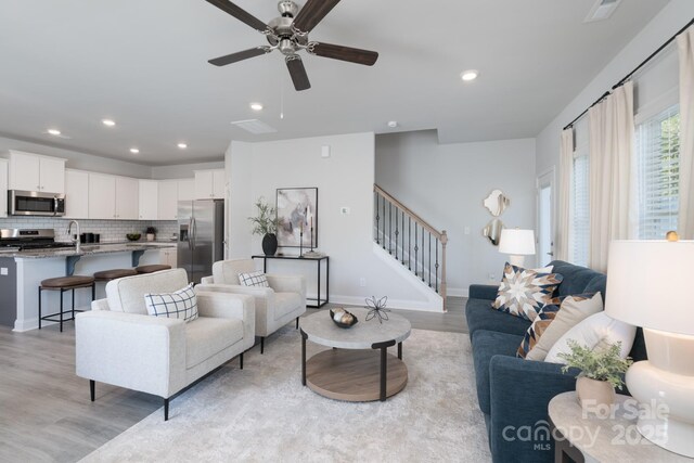 4045 Port Richmond Ave Unit 10, Gastonia, NC 28056 - living area with light wood-type flooring, stairway, a ceiling fan, recessed lighting, and baseboards