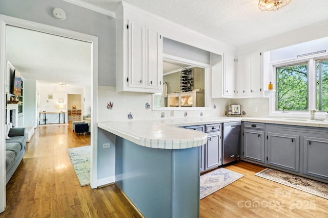 334 Lakeview Cir, Lugoff, SC 29078 - kitchen featuring gray cabinetry, dishwasher, light wood-style flooring, decorative backsplash, and crown molding