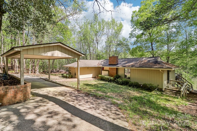 334 Lakeview Cir, Lugoff, SC 29078 - view of front of house with asphalt driveway, a chimney, a detached carport, and a front yard