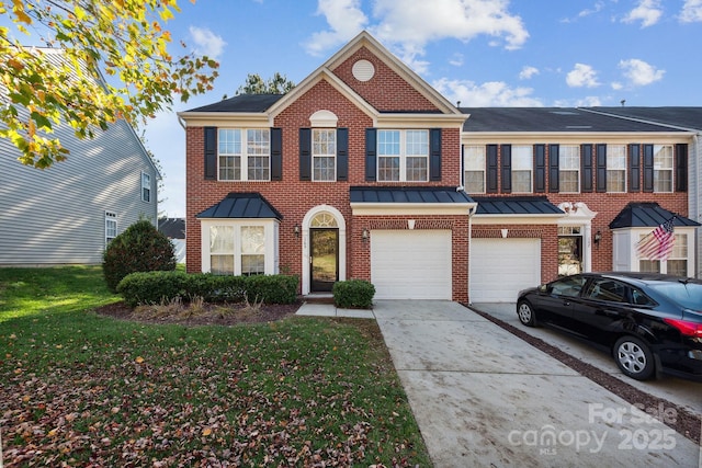 165 N Arcadian Way, Mooresville, NC 28117 - view of front of property with concrete driveway, brick siding, a standing seam roof, a garage, and a front yard