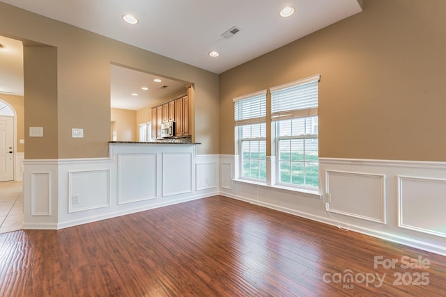 165 N Arcadian Way, Mooresville, NC 28117 - unfurnished living room featuring a decorative wall, a wainscoted wall, wood finished floors, and recessed lighting