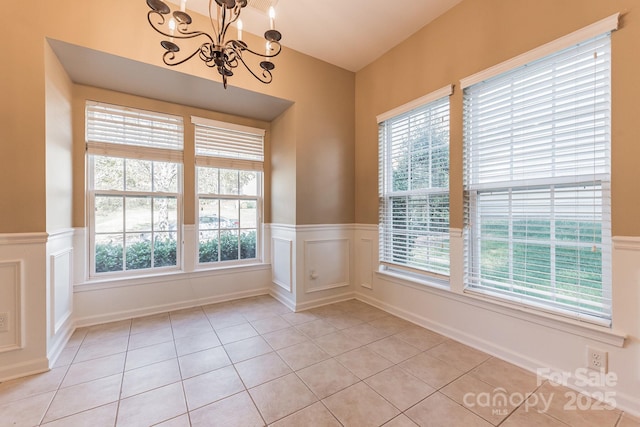 165 N Arcadian Way, Mooresville, NC 28117 - unfurnished room featuring healthy amount of natural light, a chandelier, a wainscoted wall, light tile patterned flooring, and a decorative wall