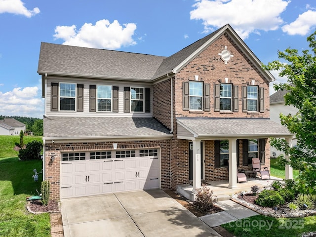 2178 Stone Pile Dr SW, Concord, NC 28025 - traditional-style house with covered porch, a garage, driveway, and brick siding