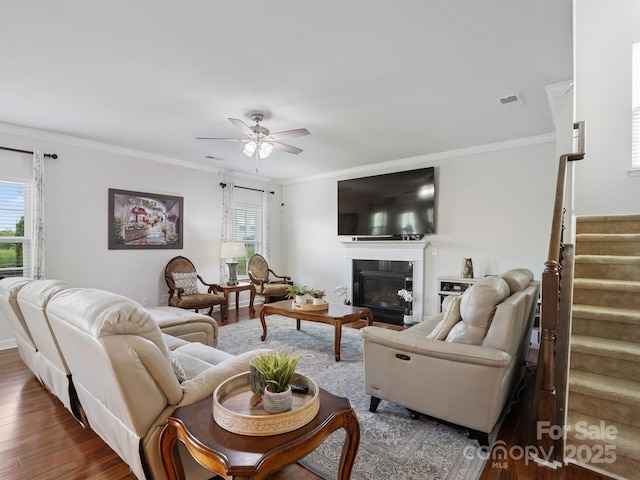 2178 Stone Pile Dr SW, Concord, NC 28025 - living room with stairway, ceiling fan, wood finished floors, ornamental molding, and a glass covered fireplace