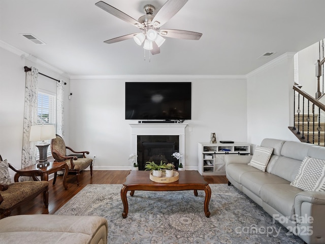 2178 Stone Pile Dr SW, Concord, NC 28025 - living area featuring wood finished floors, ornamental molding, a ceiling fan, stairs, and baseboards