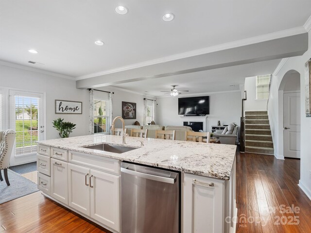 2178 Stone Pile Dr SW, Concord, NC 28025 - kitchen featuring stainless steel dishwasher, a sink, open floor plan, an island with sink, and dark wood-style floors