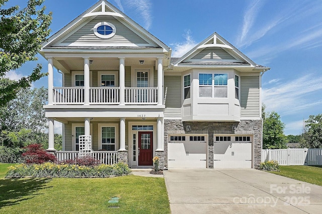 1437 Imperial Ct, York, SC 29745 - view of front of house featuring covered porch, stone siding, a balcony, driveway, and a garage